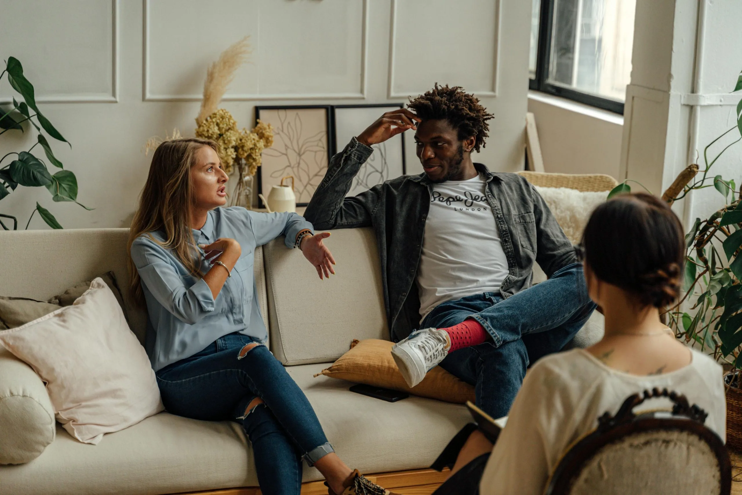 A group of people engaged in an empathetic conversation in a cozy living room, highlighting the importance of empathy in brand messaging through genuine connection and understanding.